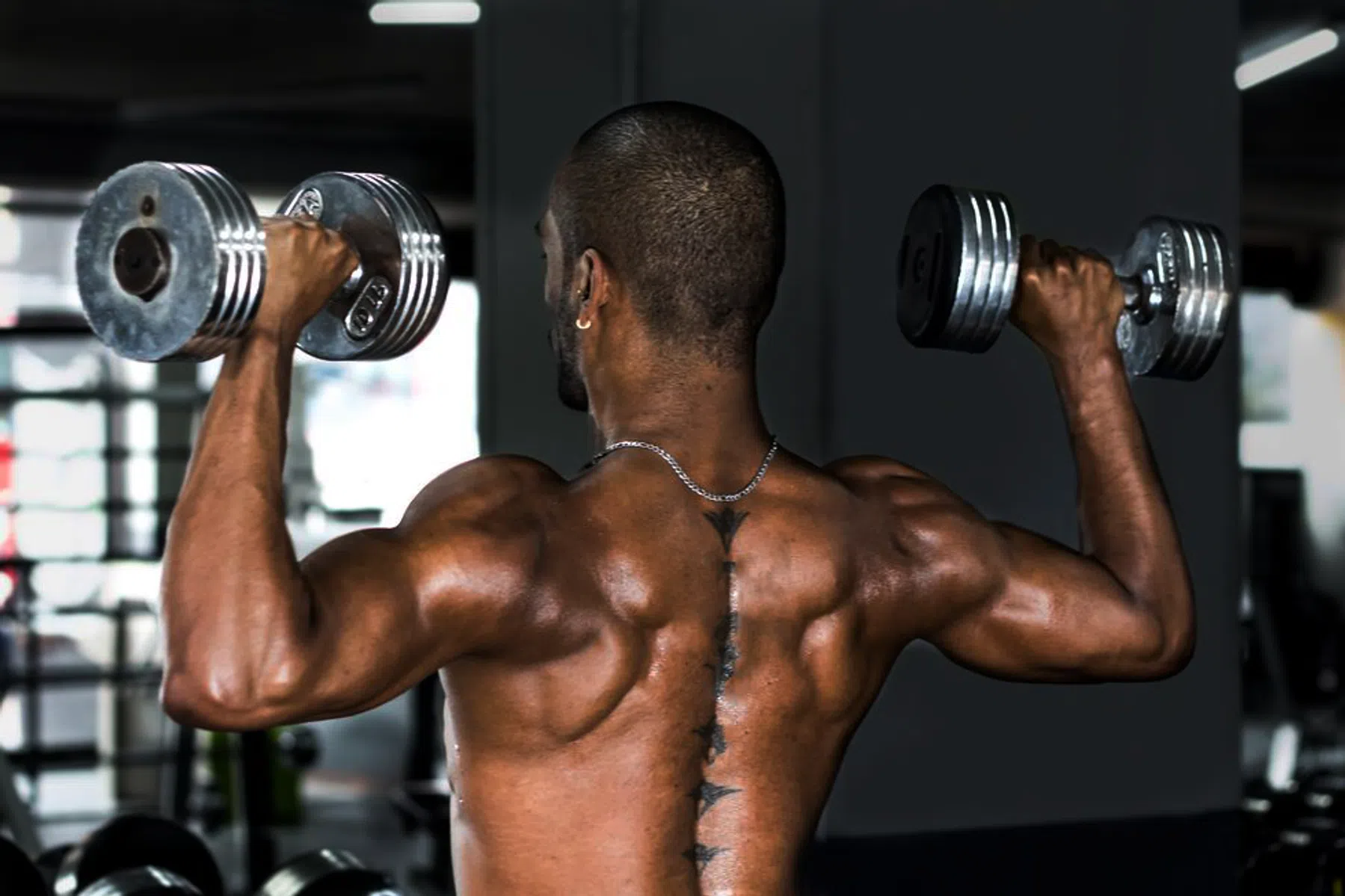 athletic-man-holding-weights-at-the-gym-royalty-free-image-1627935443.png