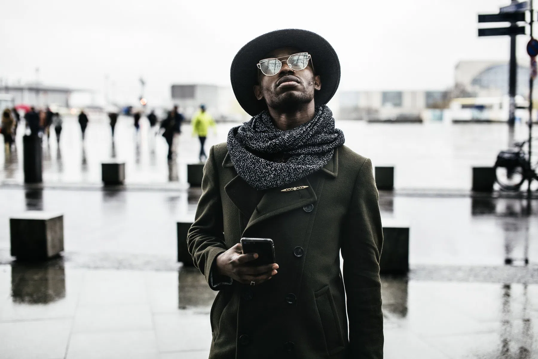 Man Looking up While Holding Smartphone